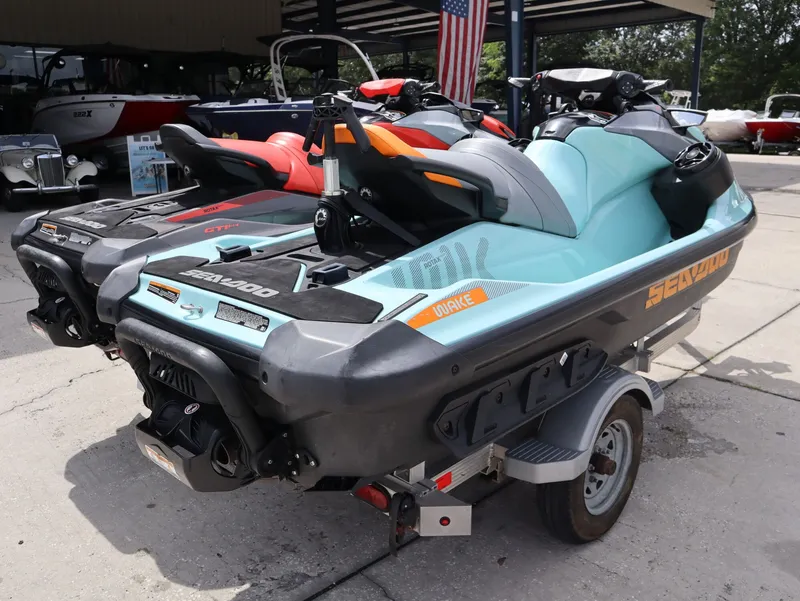 Slide: The Image of 2022 Sea-Doo GTI SE 170 jet ski on trailer, parked outdoors. - 9