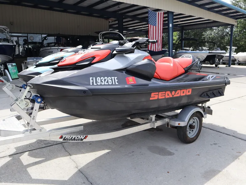 Slide: The Image of 2022 Sea-Doo GTI 130 jet ski on trailer, gray and red. - 3