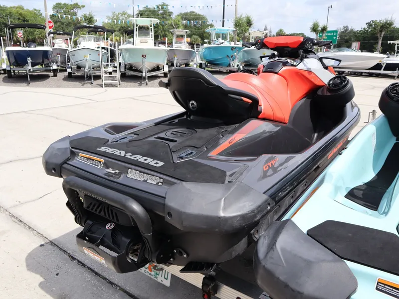 Slide: The Image of 2022 Sea-Doo GTI 130 jet ski parked outdoors. - 6