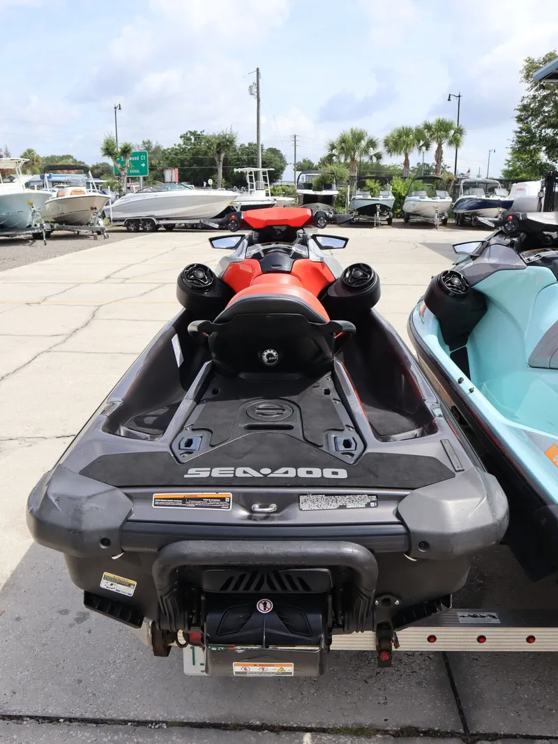 Slide: The Image of 2022 Sea-Doo GTI 130 jet ski parked outdoors. - 7