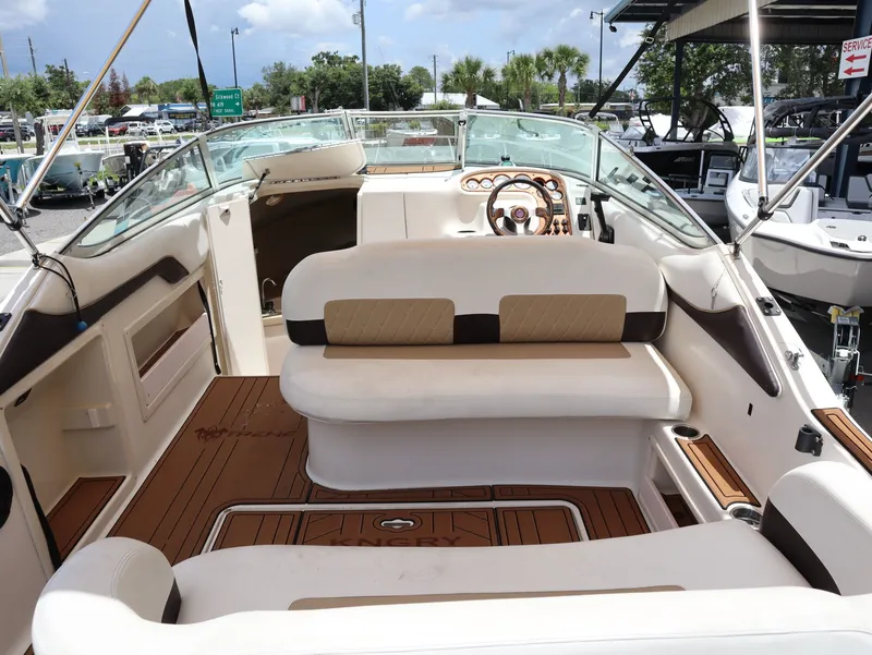 Slide: The Image of Interior of a 1998 Monterey 242 Cruiser boat with seating area. - 10