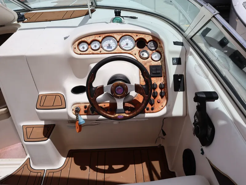 Slide: The Image of Cockpit of a 1998 Monterey 242 Cruiser with wooden steering wheel. - 11
