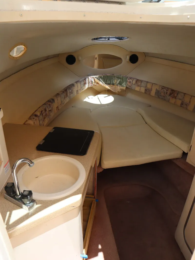 Slide: The Image of Interior of a 1998 Monterey 242 Cruiser boat with sleeping area. - 12