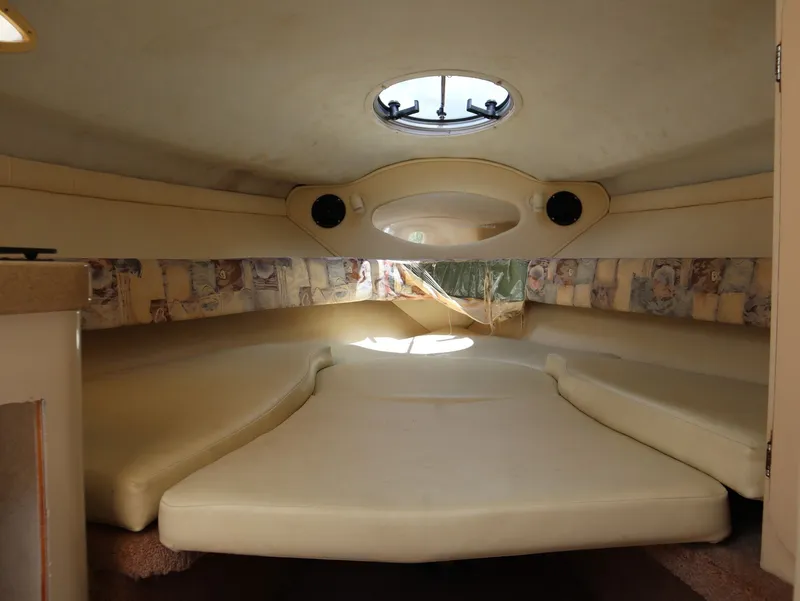 Slide: The Image of Interior of a 1998 Monterey 242 Cruiser boat with cushioned seating. - 13