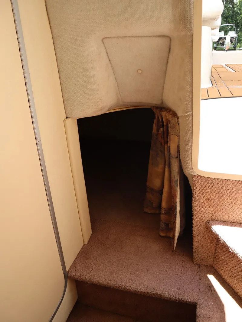 Slide: The Image of Interior of 1998 Monterey 242 Cruiser with carpeted flooring. - 16