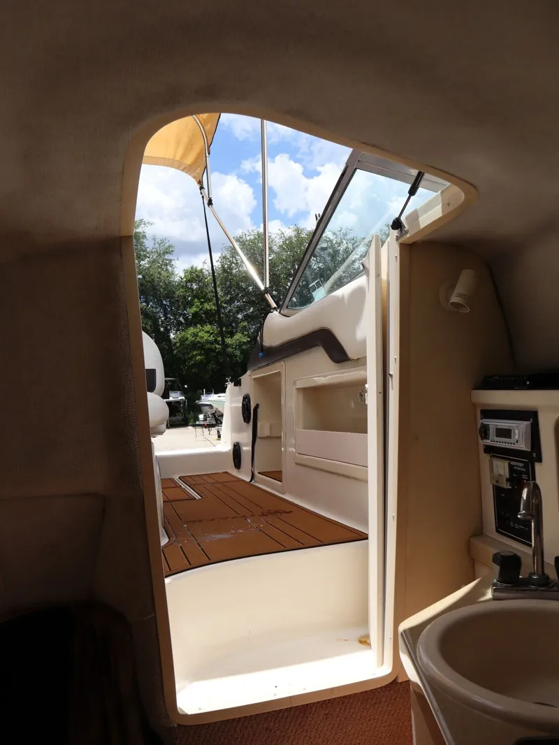 Slide: The Image of Interior of a 1998 Monterey 242 Cruiser boat with view outside. - 17