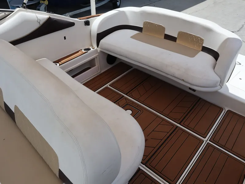 Slide: The Image of Interior of a 1998 Monterey 242 Cruiser with white seating. - 21