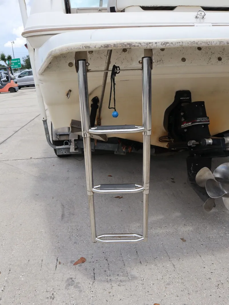 Slide: The Image of Rear view of a 1998 Monterey 242 Cruiser with ladder and propeller. - 23