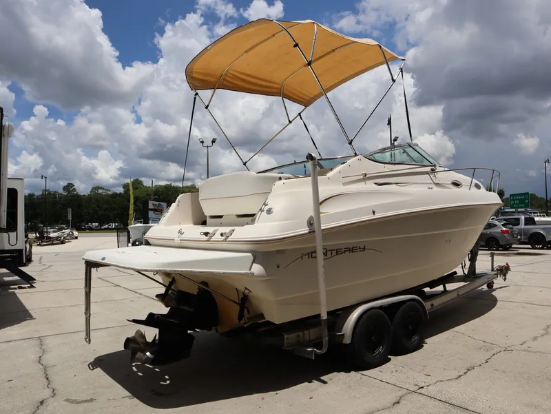 Slide: The Image of 1998 Monterey 242 Cruiser on trailer under cloudy sky. - 6