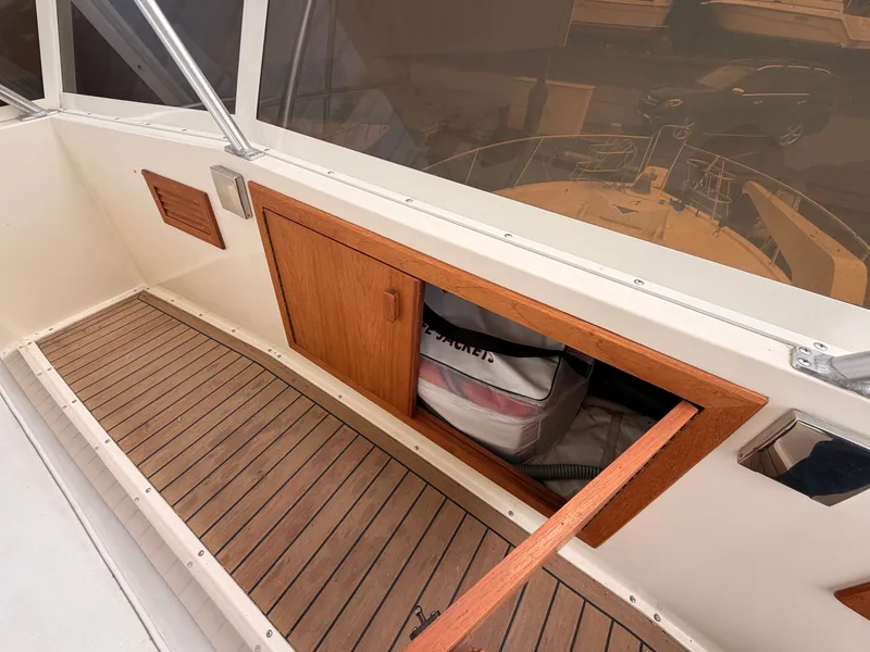 Slide: The Image of 1987 Viking DBL Cabin Yacht with wooden paneling and storage compartment. - 16