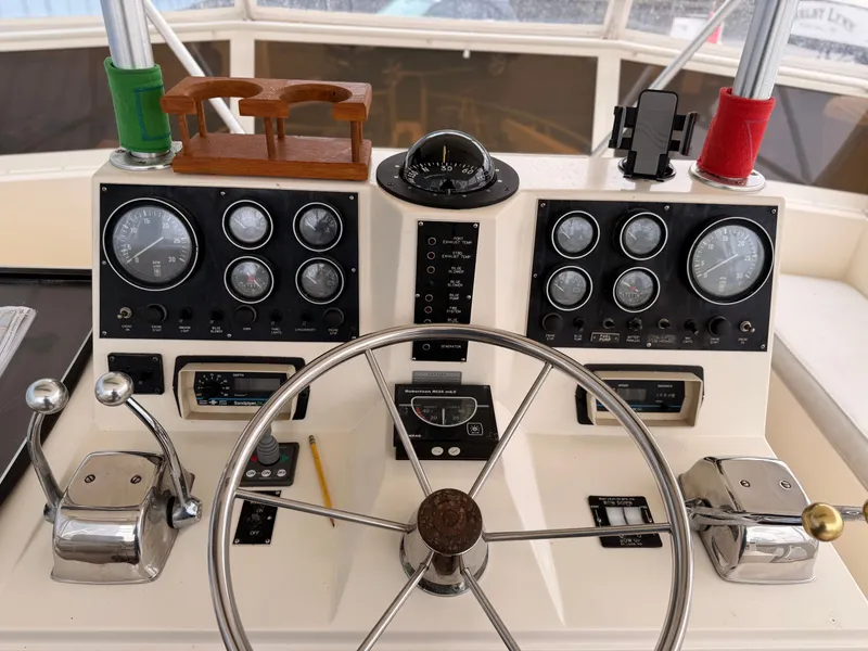 Slide: The Image of 1987 Viking DBL Cabin Motor Yacht helm with gauges and controls. - 27
