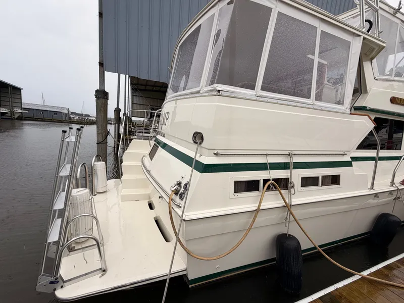 Slide: The Image of 1987 Viking DBL Cabin Motor Yacht docked at marina. - 3