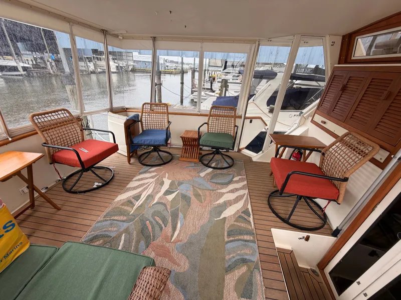 Slide: The Image of Interior of a 1987 Viking DBL Cabin Motor Yacht with cozy seating area. - 37