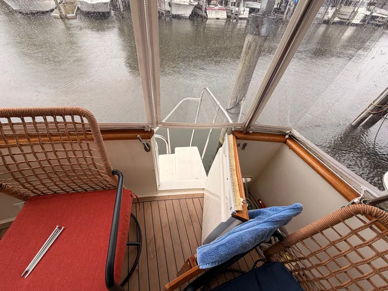 Slide: The Image of Interior of a 1987 Viking DBL Cabin Motor Yacht overlooking the harbor. - 38