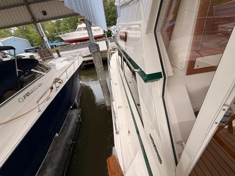 Slide: The Image of 1987 Viking DBL Cabin Motor Yacht docked at marina. - 41