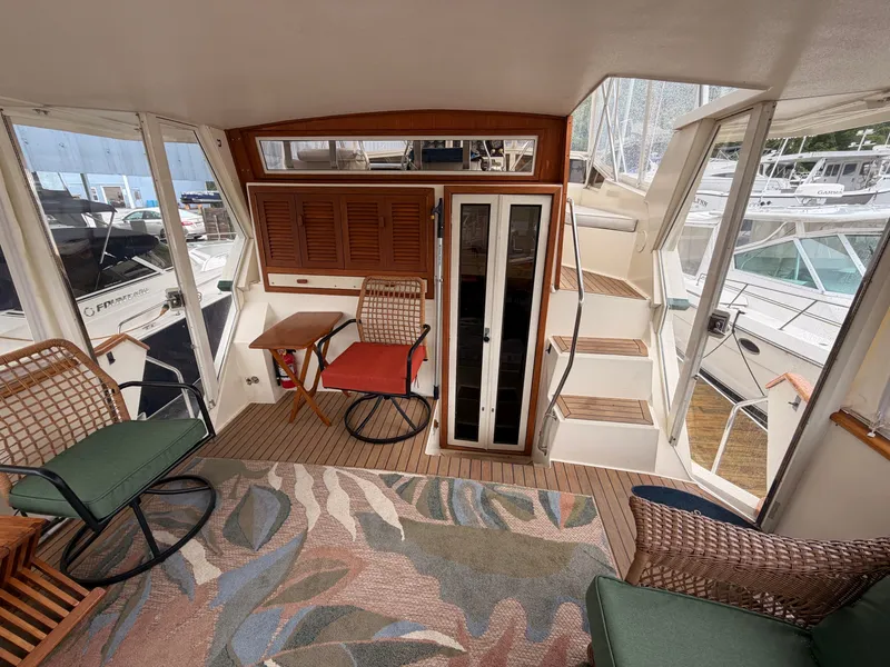 Slide: The Image of Interior of a 1987 Viking DBL Cabin Motor Yacht with cozy seating area. - 43
