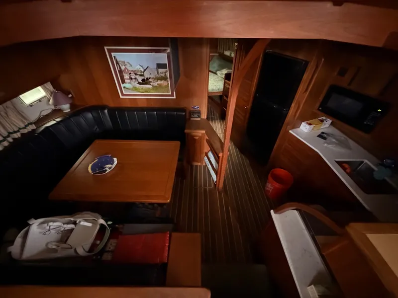 Slide: The Image of Interior of a 1987 Viking DBL Cabin Motor Yacht, cozy seating area and kitchen. - 47