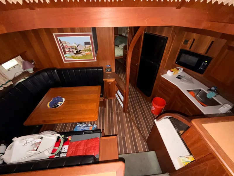 Slide: The Image of Interior of a 1987 Viking DBL Cabin Motor Yacht with kitchen and dining area. - 48