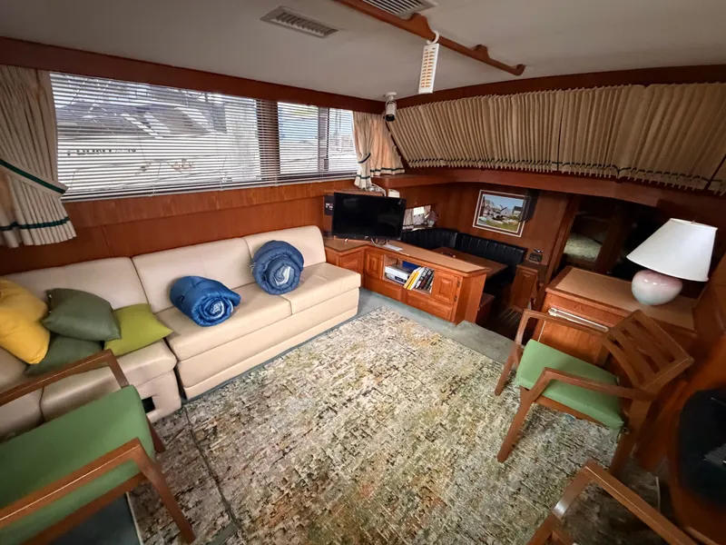 Slide: The Image of Interior of a 1987 Viking DBL Cabin Motor Yacht with sofa and TV. - 49