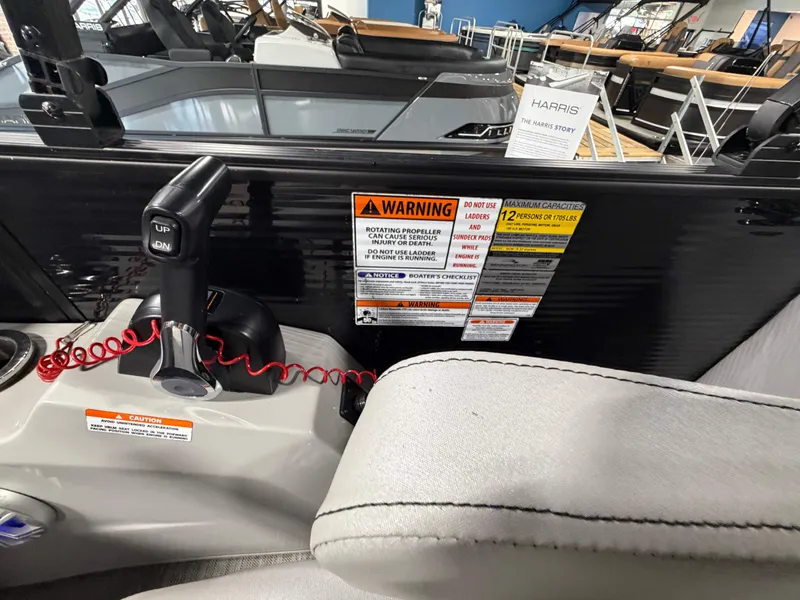 Slide: The Image of Bennington G22 2020 boat console with warning labels and control lever. - 14