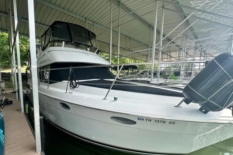 The Image of 1998 Carver 355 Aft Cabin Motor Yacht docked in covered marina. - 0