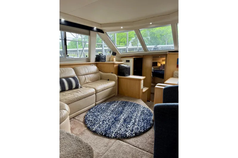 Slide: The Image of Luxurious interior of 1998 Carver 355 Aft Cabin Motor Yacht with plush seating. - 11
