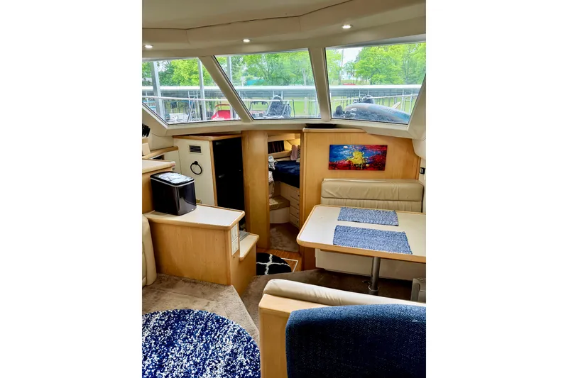 Slide: The Image of Interior of 1998 Carver 355 Aft Cabin Motor Yacht with dining area and modern decor. - 13
