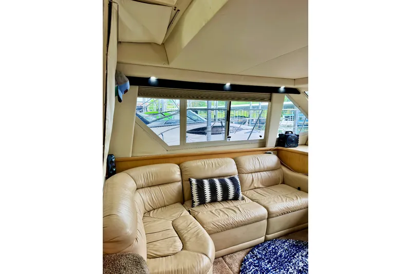 Slide: The Image of Interior of 1998 Carver 355 Aft Cabin Motor Yacht with beige leather seating. - 14