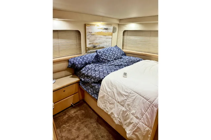 Slide: The Image of Cozy bedroom in 1998 Carver 355 Aft Cabin Motor Yacht with blue bedding. - 18