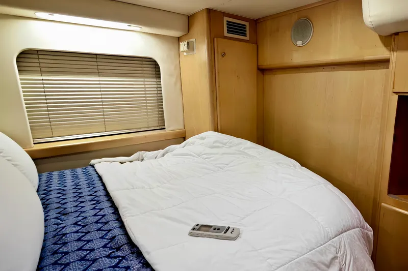 Slide: The Image of Cozy bedroom in 1998 Carver 355 Aft Cabin Motor Yacht with window blinds and remote control. - 19
