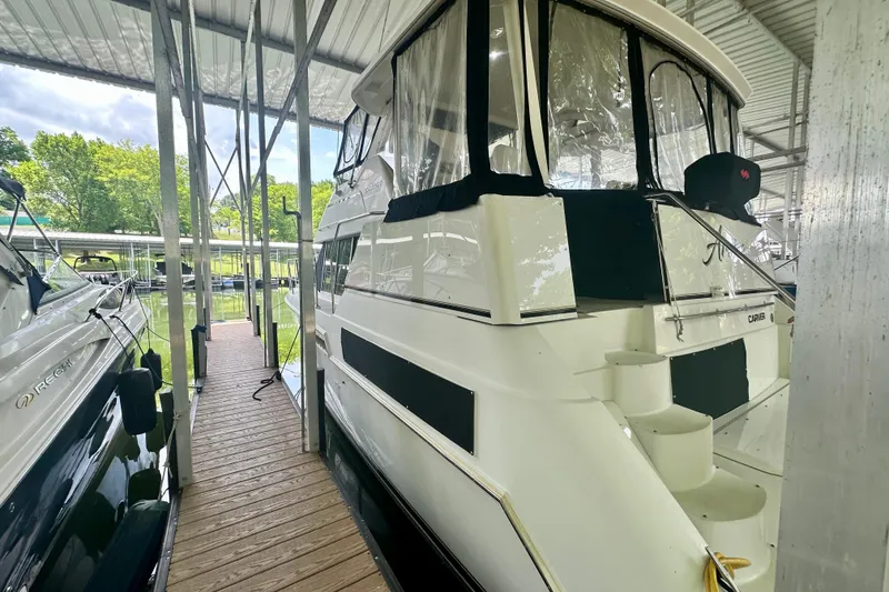 Slide: The Image of 1998 Carver 355 Aft Cabin Motor Yacht docked in a marina. - 2