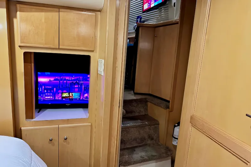 Slide: The Image of Interior of 1998 Carver 355 Aft Cabin Motor Yacht with TV and wooden cabinetry. - 20
