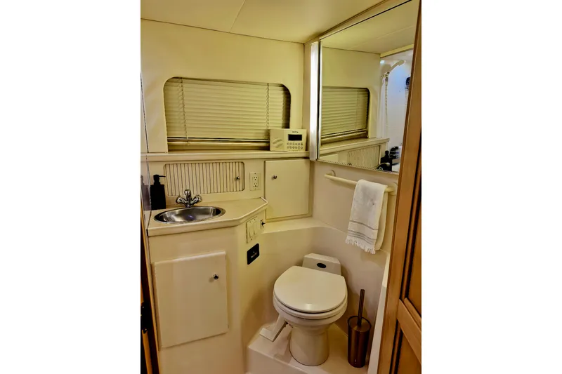 Slide: The Image of Bathroom interior of 1998 Carver 355 Aft Cabin Motor Yacht, featuring sink and toilet. - 22