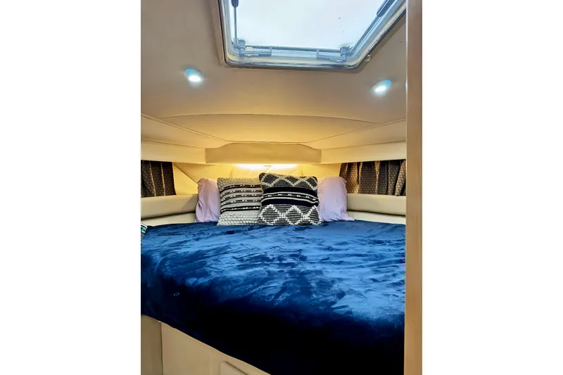 Slide: The Image of Cozy cabin interior of 1998 Carver 355 Aft Cabin Motor Yacht with plush bedding. - 23