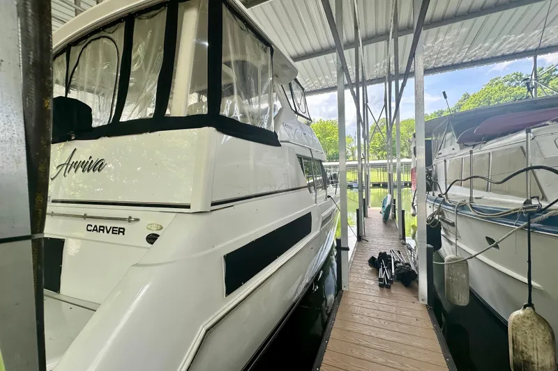 Slide: The Image of 1998 Carver 355 Aft Cabin Motor Yacht docked in a covered marina. - 3