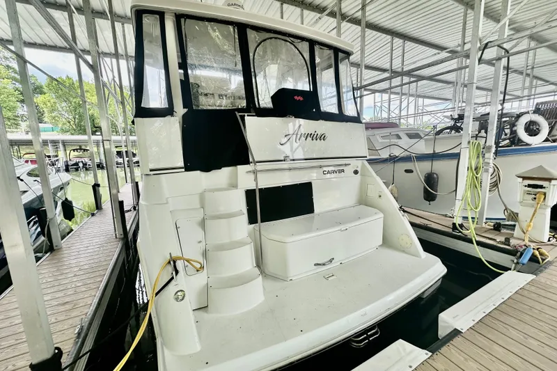 Slide: The Image of 1998 Carver 355 Aft Cabin Motor Yacht docked in a marina. - 4