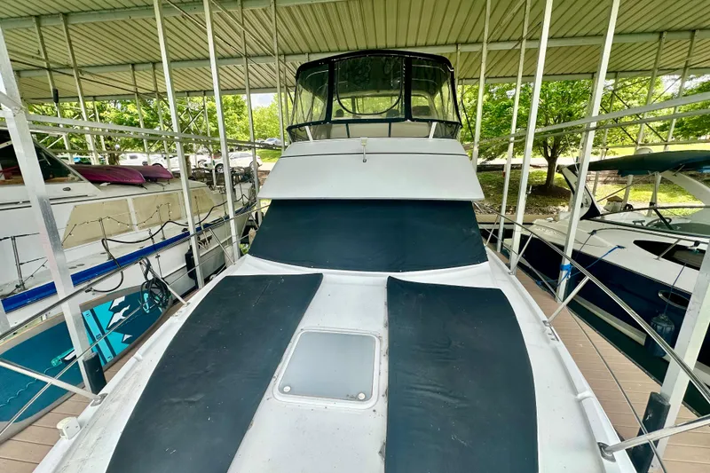 Slide: The Image of 1998 Carver 355 Aft Cabin Motor Yacht docked under a covered marina. - 5