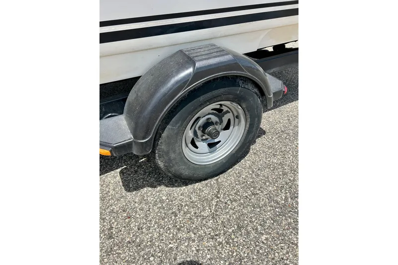 Slide: The Image of Trailer wheel of a 2001 Sea Ray 182 Bow Rider on asphalt. - 10