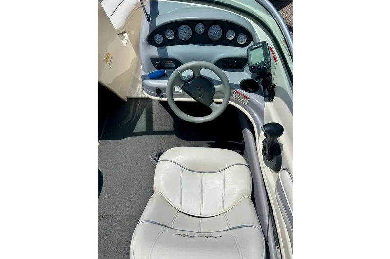 Slide: The Image of 2001 Sea Ray 182 Bow Rider cockpit with steering wheel and instrument panel. - 14