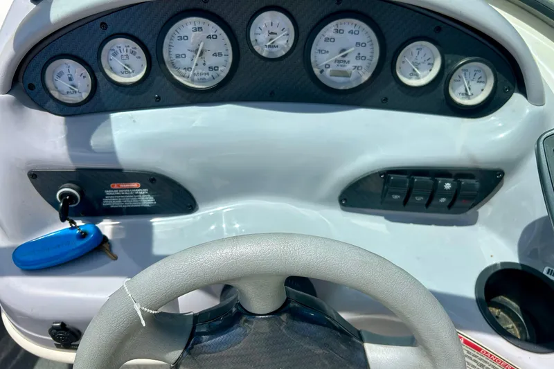 Slide: The Image of Dashboard of a 2001 Sea Ray 182 Bow Rider boat with gauges and controls. - 17