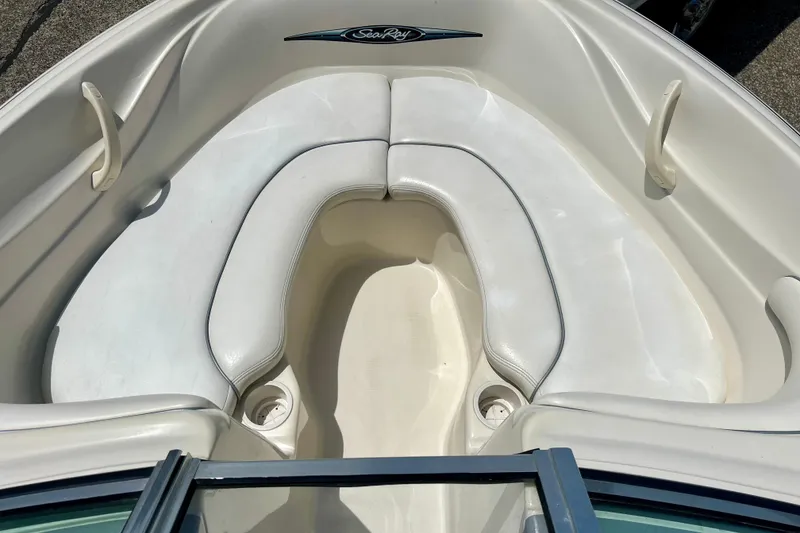 Slide: The Image of 2001 Sea Ray 182 Bow Rider boat interior with white seating and cup holders. - 22
