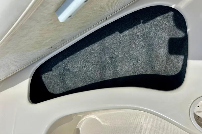 Slide: The Image of Interior detail of a 2001 Sea Ray 182 Bow Rider boat, featuring a carpeted panel. - 24