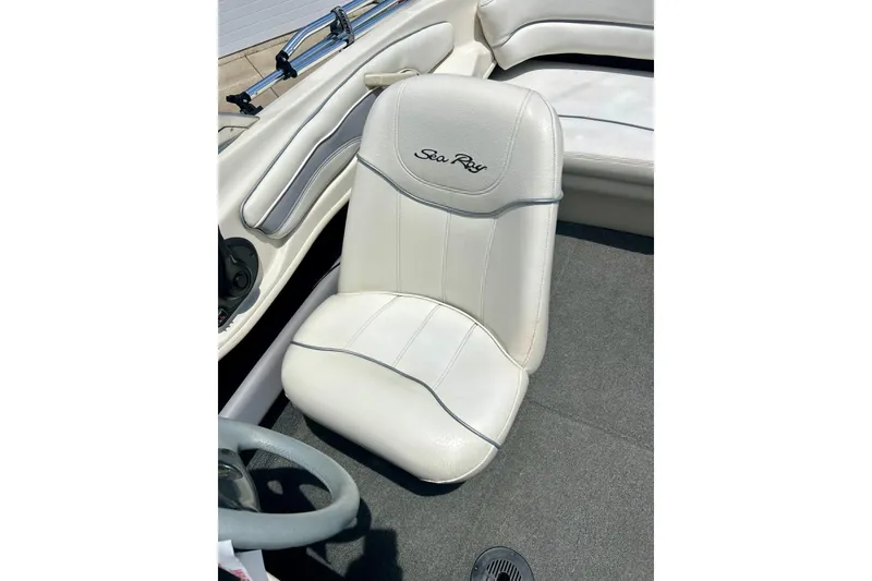 Slide: The Image of 2001 Sea Ray 182 Bow Rider interior with white seating and steering wheel. - 28