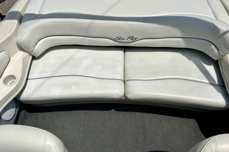 Slide: The Image of 2001 Sea Ray 182 Bow Rider boat interior with white cushioned seating. - 33