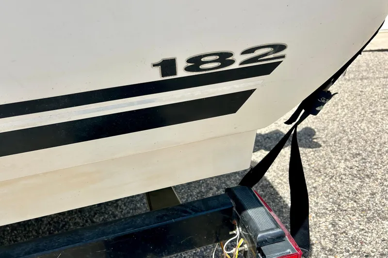 Slide: The Image of 2001 Sea Ray 182 Bow Rider boat detail with trailer and strap. - 7
