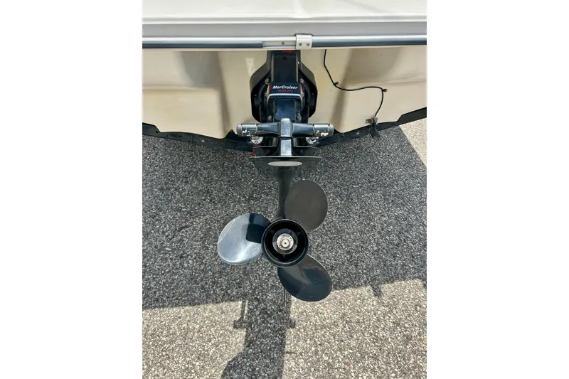Slide: The Image of 2001 Sea Ray 182 Bow Rider boat propeller and outdrive on pavement. - 8