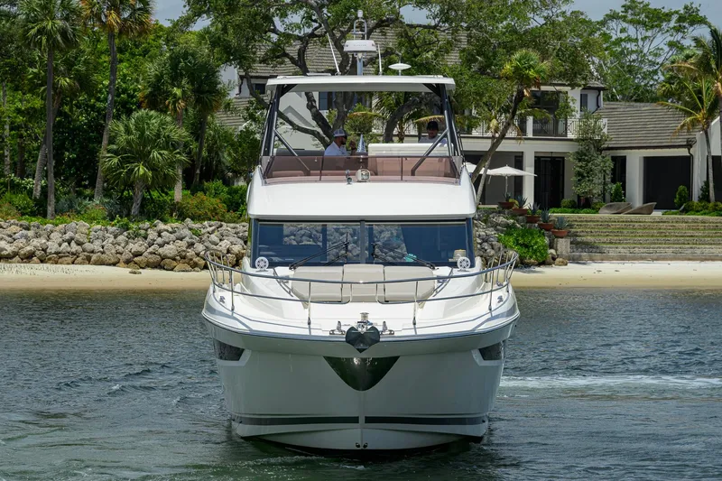 Slide: The Image of Front view of a 2021 Prestige 520 yacht near a tropical shoreline. - 38