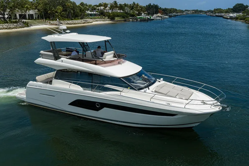 Slide: The Image of Luxury 2021 Prestige 520 yacht cruising on a scenic waterway. - 41