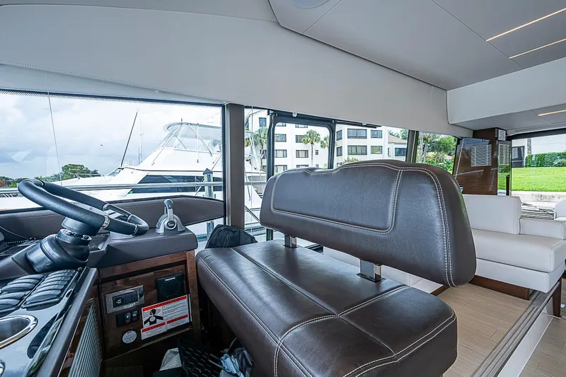 Slide: The Image of Interior of 2021 Prestige 520 yacht with leather seating and steering wheel. - 62