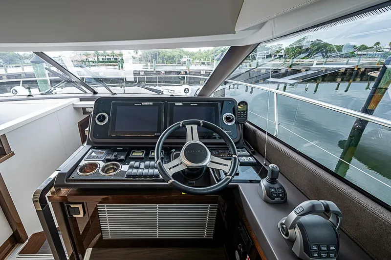 Slide: The Image of Helm of 2021 Prestige 520 yacht with modern navigation controls and panoramic view. - 63